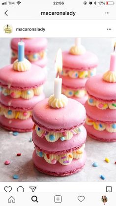 some pink cupcakes with candles on them