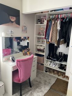 a dressing room with a pink chair and lots of closet space