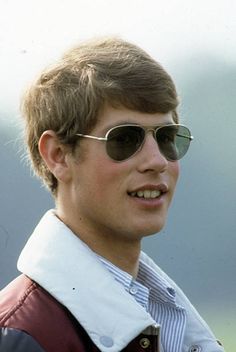 a young man wearing sunglasses and a vest