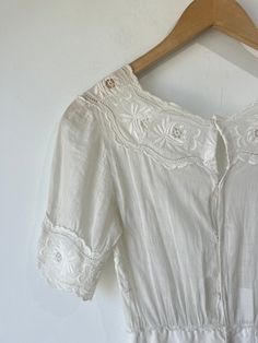 Vintage Victorian Sheer Embroidered Dress. Delicate cotton with short sleeves, waist cinch, and button down the back. In excellent vintage condition. One stain on the skirt visible in photos attached. Hand wash cold and line dry, very delicate. Best fits XS. Approximate measurements:Underarm to underarm: 16.5"Waist: 12" across laying flat.Length: 50" Cottagecore Embroidered Short Sleeve Dress, Vintage Summer Dress With Lace Trim And Short Sleeves, Summer Vintage Dress With Lace Trim And Short Sleeves, Bohemian Short Sleeve Broderie Anglaise Dress, Short Sleeve Cotton Dress With Broderie Anglaise, Cotton Broderie Anglaise Dress With Short Sleeves, White Cotton Vintage Dress With Short Sleeves, Vintage Broderie Anglaise Dress For Daywear, Peasant Style Short Sleeve Day Dress