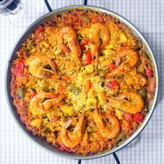 an overhead view of a paella with shrimp and rice