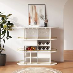 a white shelf with some glasses on it and a potted plant in the corner