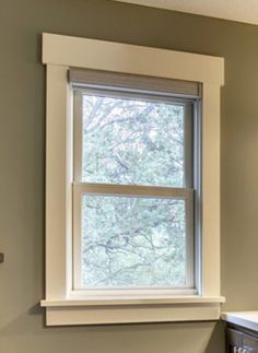 a bathroom with a sink, mirror and window in it's center area is shown