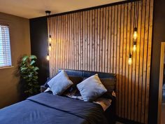 a bed sitting in a bedroom next to a window with wooden slats on it