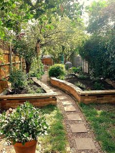 an outdoor garden with stone walkways and potted plants on the side of it