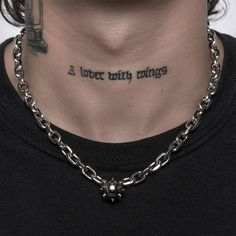 a man with a chain around his neck has a tattoo that reads, i love my things