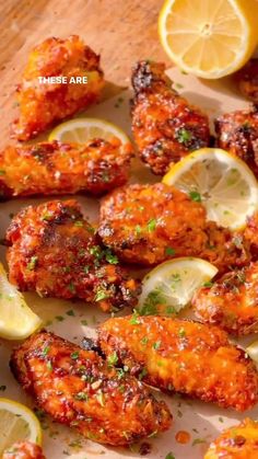 chicken wings with lemons and parsley on a cutting board