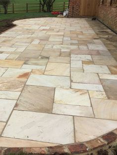 an outdoor patio with stone pavers and brick walls