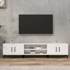 an entertainment center with a flat screen tv mounted on the wall