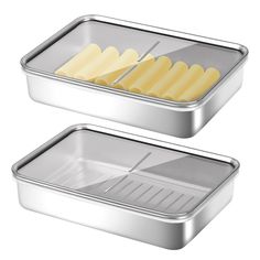 two metal trays with pasta and cheese sticks in them on a white background photo