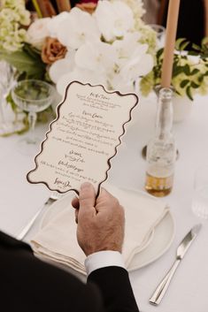 a close up of a person holding a menu at a table