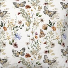 a white pillow with butterflies and flowers on it