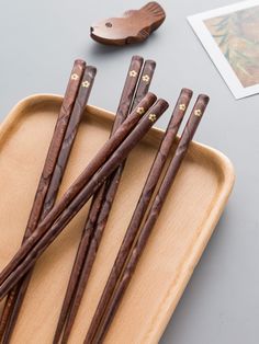 wooden chopsticks are sitting on a tray