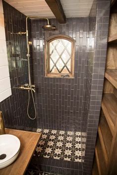 a bathroom with black and white tiled walls