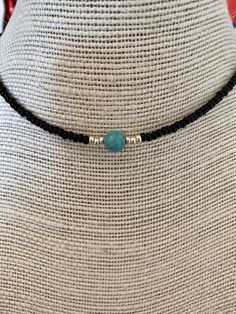 "This hand-made beaded choker necklace is perfect for any occasion. The necklace is made with mostly black beads. A statement turquoise stone sits in the middle, surrounded by silver beads.  3 sizes available: 14\" (most common for women), 16\" and 18\" (most common for men). These sizes are measured at the loosest point of the necklace but can be adjusted to be slightly tighter. Please check your size before ordering and message me if you have any questions or measurement requests. Disclaimer: Adjustable Turquoise Jewelry With Black Beads, Handmade Adjustable Black Turquoise Necklace, Turquoise Jewelry With Black Beads, Bohemian Adjustable Black Turquoise Necklace, Adjustable Black Beaded Turquoise Necklace, Beaded Necklace Black, Turquoise Choker, Turquoise Bead Necklaces, Beaded Choker Necklace