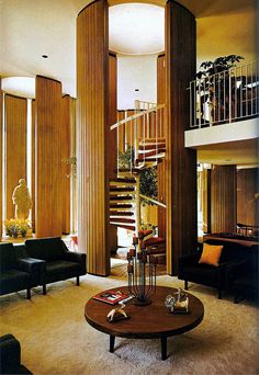 a living room filled with furniture and a spiral staircase