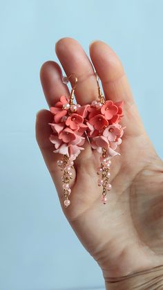 https://purplebeestudio.etsy.com Handmade unique polymer clay chandelier earrings in soft peach colour. These very elegant earrings will become your favorits for many occasions day or night. Perfect gift for a special woman in your life. Earrings made with brass ear wire. The earrings are very light and comfortable to wear all day. SHIPPING: Your order will be dispatched in a securely packed cardboard box. Product care:  - To ensure the product quality and durablility, avoid contact with water, lotion, perfumes and household cleaners and chemicals. - You can clean the products with a slightly damp soft fabric.  - Sharp objects can damage the clay surface. - When not in use, store in a dry, seperate box. Thank you for visiting my shop! If you have any special requests, I'll be happy to do m Pink Polymer Clay Flower Earrings For Weddings, Pink Clay Jewelry With Ear Wire, Handmade Coral Earrings For Wedding, Pink Clay Dangle Earrings, Pink Polymer Clay Earrings With 3d Flowers, Pink 3d Flower Polymer Clay Earrings, Handmade Peach Dangle Earrings, Handmade Pink Polymer Clay Flower Earrings, Pink Clay Drop Earrings