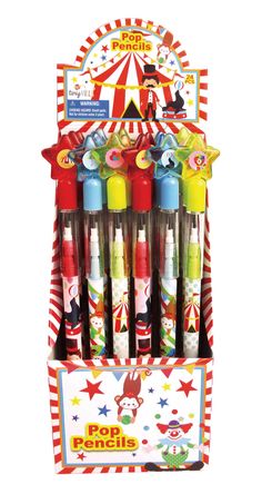 an assortment of different colored pens in a display case with circus theme on the front