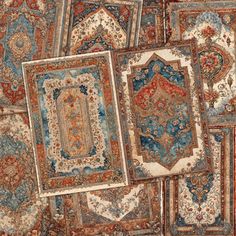 an assortment of rugs are arranged on the floor