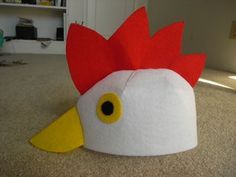 a paper hat with a chicken on it's head is sitting on the floor