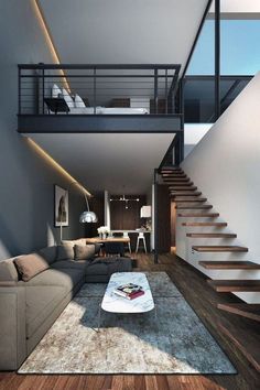 a modern living room with stairs leading up to the second floor