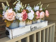 some flowers are sitting in mason jars on a porch rail with the word gena written below them