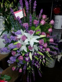 a bunch of flowers that are sitting on a table in front of some other items