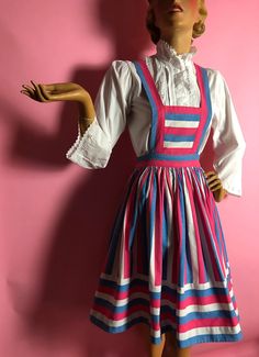 This is so fun.  It is a pinafore dress.  It is made from a thick mid-weight cotton and it designed to make effective use of the stripes.  I was told it was 1940s.  If so it is late 40s, possibly into the 1950s.  The skirt has a waistband with a Ruhr metal zip (which I suspect is a replacement as I can see evidence of a change of zipper).  The skirt itself is quite full, full circle.  The stripes are vertical for the most part but there is a band of horizontal stripes near the hem.  The skirt hi Vintage Fitted Pinafore Dress For Spring, Vintage Fitted Pinafore Dress, Fitted Vintage Pinafore Dress For Summer, 1950s Prom Dress, Homemade Dress, Dresses 40s, Houndstooth Skirt, Dress Knee Length, White Sky