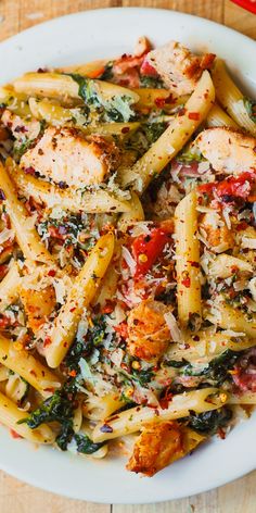 a white plate topped with pasta and chicken