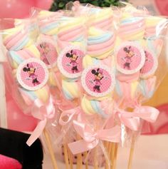 a bunch of lollipops with minnie mouse decorations on them sitting in a vase