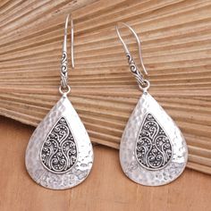 Artisan Ketut Udiana adds traditional Balinese motifs to a stunning sterling silver design. These exquisite dangle earrings feature hammered details surrounding the centerpieces. The hooks allow the accessory to dangle gracefully, making an alluring addition to your jewelry collection. Silver Hammered Bohemian Earrings, Traditional Silver Drop Jewelry, Bohemian Silver Hammered Earrings, Traditional Silver Hammered Earrings, Bohemian Hammered Sterling Silver Earrings, Traditional Hammered Silver Earrings, Bohemian Sterling Silver Hammered Earrings, Silver Drop Artisan Earrings, Artisan Silver Drop Earrings