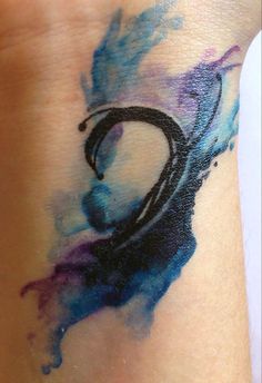 a wrist tattoo with the letter d painted on it's arm and an abstract design