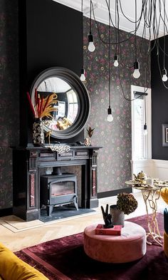 a living room filled with furniture and a fire place under a mirror on the wall