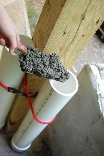 a person is holding something in their hand near some white cups with red cords attached to them