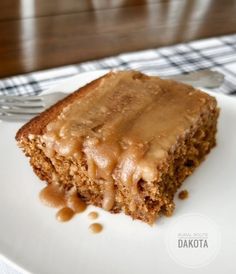 a close up of a piece of cake on a plate with a fork in it