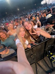 a group of young people standing next to each other in front of a crowd at a concert