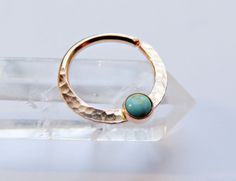 This moonstone septum ring is handmade by me with gold filled hard wire and hammered for texture (gold filled wire is different than gold plated in that it will never tarnish). Soldered onto the ring is a 3mm gold filled setting with a 3mm turquoise stone set inside of it. Please note that you will not receive the exact stone pictured, and that due to the nature of natural turquoise, the color will vary. Some stones are greener, some are bluer, some are more teal. I am at the mercy of my supplie Gold Septum Piercing, Bijoux Piercing Septum, Cute Septum Rings, Gold Septum Ring, Daith Ring, Opal Septum, Piercing Daith, Gold Septum, Septum Piercing Jewelry