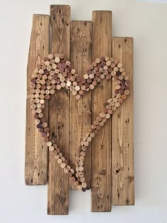 a heart made out of wooden planks on a wall