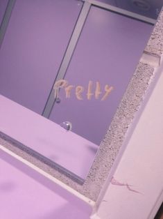 there is a purple bathroom with the word pretty written on it