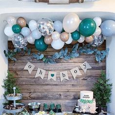 a table topped with lots of food and balloons