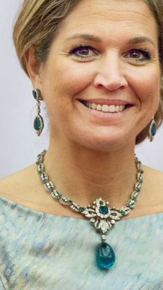 a woman wearing a necklace and earrings