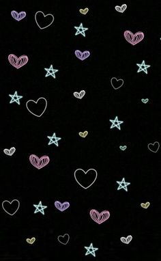 many hearts and stars on a black background