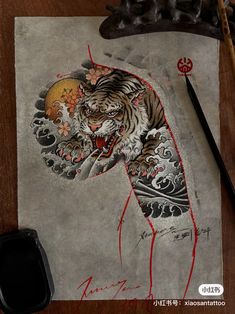 a drawing of a tiger on a piece of paper with a mouse next to it