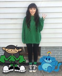 a woman standing next to two cut outs of cartoon characters