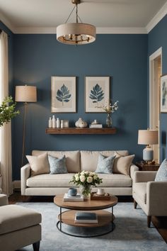 a living room with blue walls and white furniture in the center, along with two couches and a coffee table