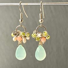 Gorgeous multi gemstone cluster drop earrings with pastel colored semi precious stones, made by me into a short dangle.  Lovely hypoallergenic beaded earrings made from tarnish free stainless steel which is great for sensitive individuals with pierced ears consisting of soft colours of light green peridot, blush pink morganite and white freshwater seed pearls from which I have hand wire wrapped and dangled aqua blue chalcedony smooth teardrop briolettes. Beautiful and cute mothers Day or Christm Pastel Dangle Jewelry For Gifts, Pastel Drop Earrings Jewelry As Gift, Christmas Gifts Sister, Color Stone Earrings, Gifts Sister, Pastel Jewelry, Gemstone Earrings Dangle, Christmas Gifts For Sister, Chalcedony Earrings