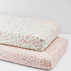 two pillows sitting side by side on top of each other