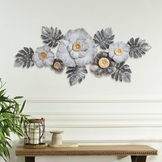 a wall decoration with flowers and leaves on it