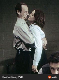 two people kissing each other in front of a brick wall with the caption posted in svu