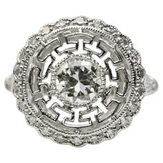 An Art Deco style diamond engagement ring crafted in platinum. Centered by a 0.74 carat bezel set old European cut diamond of I color and VS1 clarity set in a miligrain beaded bezel. Accented by 28 pave set diamonds and a pierced greek key motif surrounding the center diamond. Hallmarked, and tested as Platinum. Measurements: 16mm Across with a Rise of 4mm. Weight: 6.2 Grams. Floral Wedding Bands, Art Deco Floral, Ring Crafts, European Cut Diamonds, Greek Key, How To Make Notes, Art Deco Style, Jewelry Rings Engagement, Deco Style